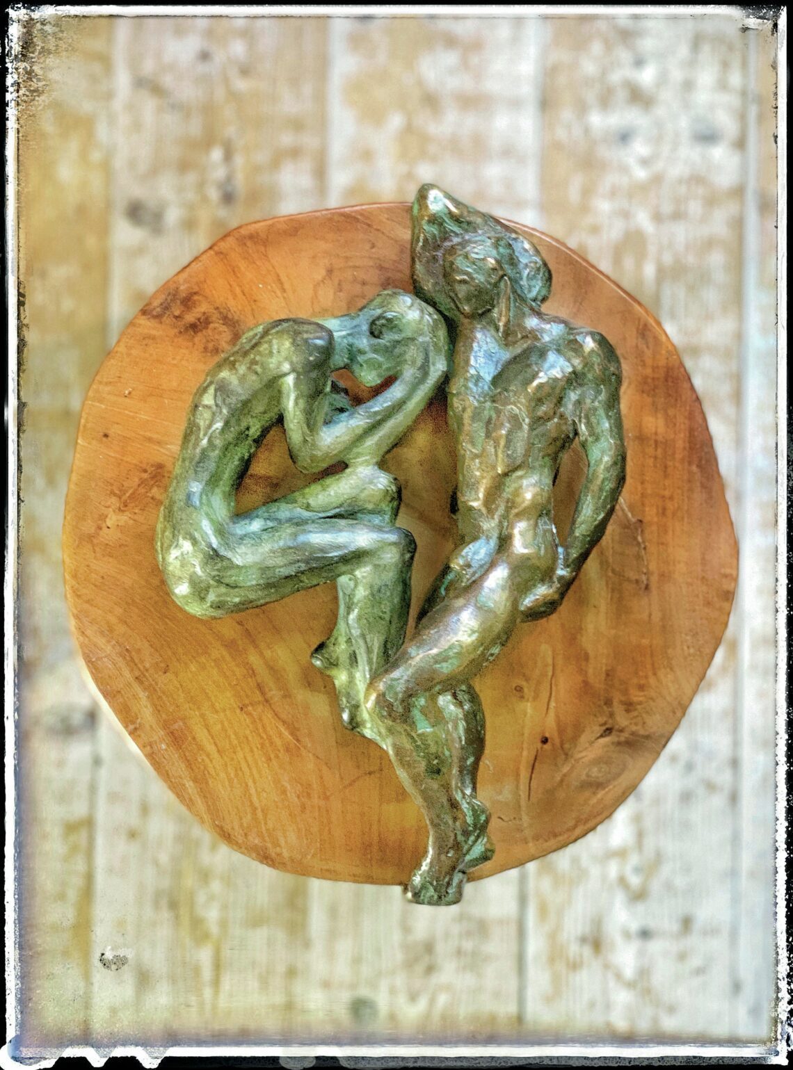 Twee bronzen beeldjes. Eentje van de heilige Sebastiaan en de andere van een man in foetushouding.